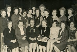 Panevėžio mergaičių gimnazijos 1945 m. absolvenčių ir pedagogų susitikimas. 1-oje eilėje iš kairės: Elzė Ulenskaitė, mokytoja Elena Gabulaitė, Ksavera Kuncytė-Skrinskienė, mokytoja Ona Daugaravičiūtė, Regina Šumskytė, Liucija Lukoševičiūtė-Šapailienė, Gina Aleksandravičiūtė-Ramūnienė; 2-oje eilėje iš kairės: Eugenija Linkevičiūtė-Vaitiekūnienė, Valerija Varevičiūtė-Ciemnolonskienė, Aldona Motiejūnaitė-Jagminienė, Eugenija Šukytė, Aleksandra Žankauskaitė-Banelienė, Liuda Jokubonytė, Ona Bučiūnaitė, Aldona Venskūnaitė-Kaulakienė, Jūratė Liutkevičiūtė-Grimailovienė, Regina Uzielaitė-Diktanienė, Viktorija Venskevičiūtė-Ilčiukienė, Sofija Klišytė-Laumenskienė, Eugenija Vareikaitė. Panevėžys. 1965 m. PAVB RKRS F9-1282