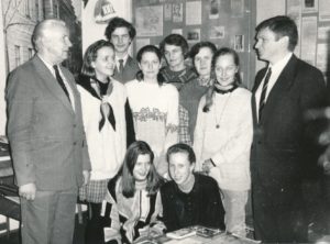 Panevėžio Juozo Balčikonio gimnazijos direktorius Raimondas Dambrauskas (dešinėje), gimnazijos istorijos muziejaus vadovas Vytautas Baliūnas (kairėje), mokytoja Lionė Lapinskienė (centre) su moksleiviais gimnazijos istorijos muziejuje. Fotogr. J. Lindos. Panevėžys. 1994 m. Panevėžio apskrities G. Petkevičaitės-Bitės viešoji biblioteka, Pavienių rankraščių fondas F8-233