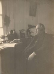 Raguvos Švč. Mergelės Marijos Ėmimo į dangų parapijos klebonas Jonas Maciejauskas savo darbo kambaryje klausosi radijo. Raguva (Panevėžio r.). Apie 1930 m. PAVB, Pavienių rankraščių fondas F8-660-3